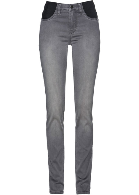 Oprijete kavbojke s srednje visokim pasom in stretch materialom